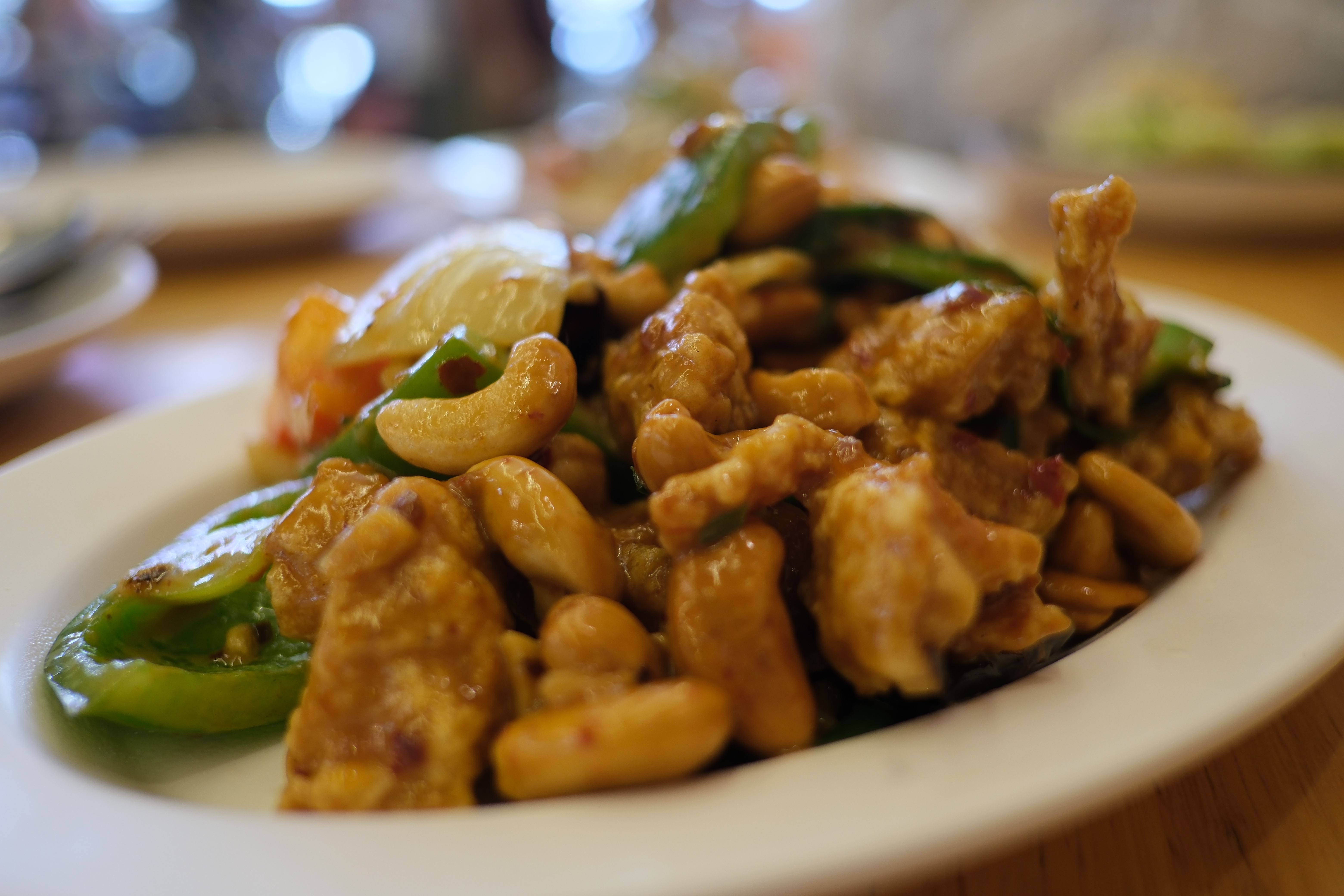 Cashew chicken stir fry with bell peppers in glossy sauce