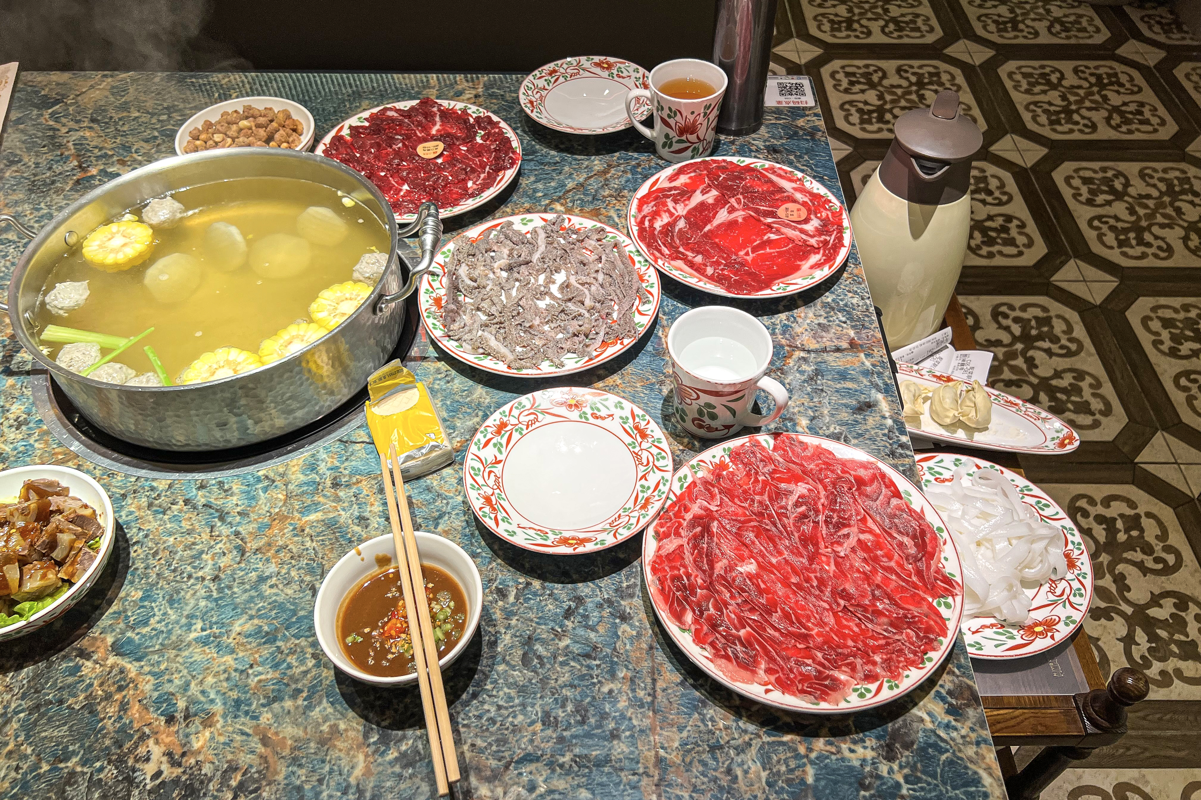 Chaoshan beef hotpot with thin-sliced raw beef and vegetables in clear broth