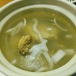 Hainanese coconut chicken soup with coconut meat and chicken in clear broth