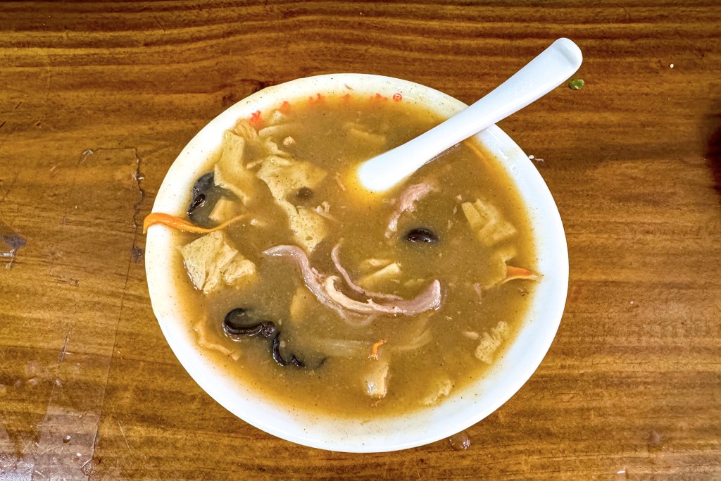 A bowl of Henan hulatang, thick peppery breakfast soup, served at Xiaoyao Town
