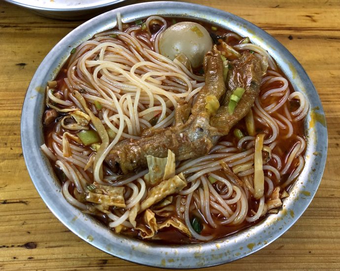 Liuzhou Luosifen rice noodles in spicy snail broth with toppings