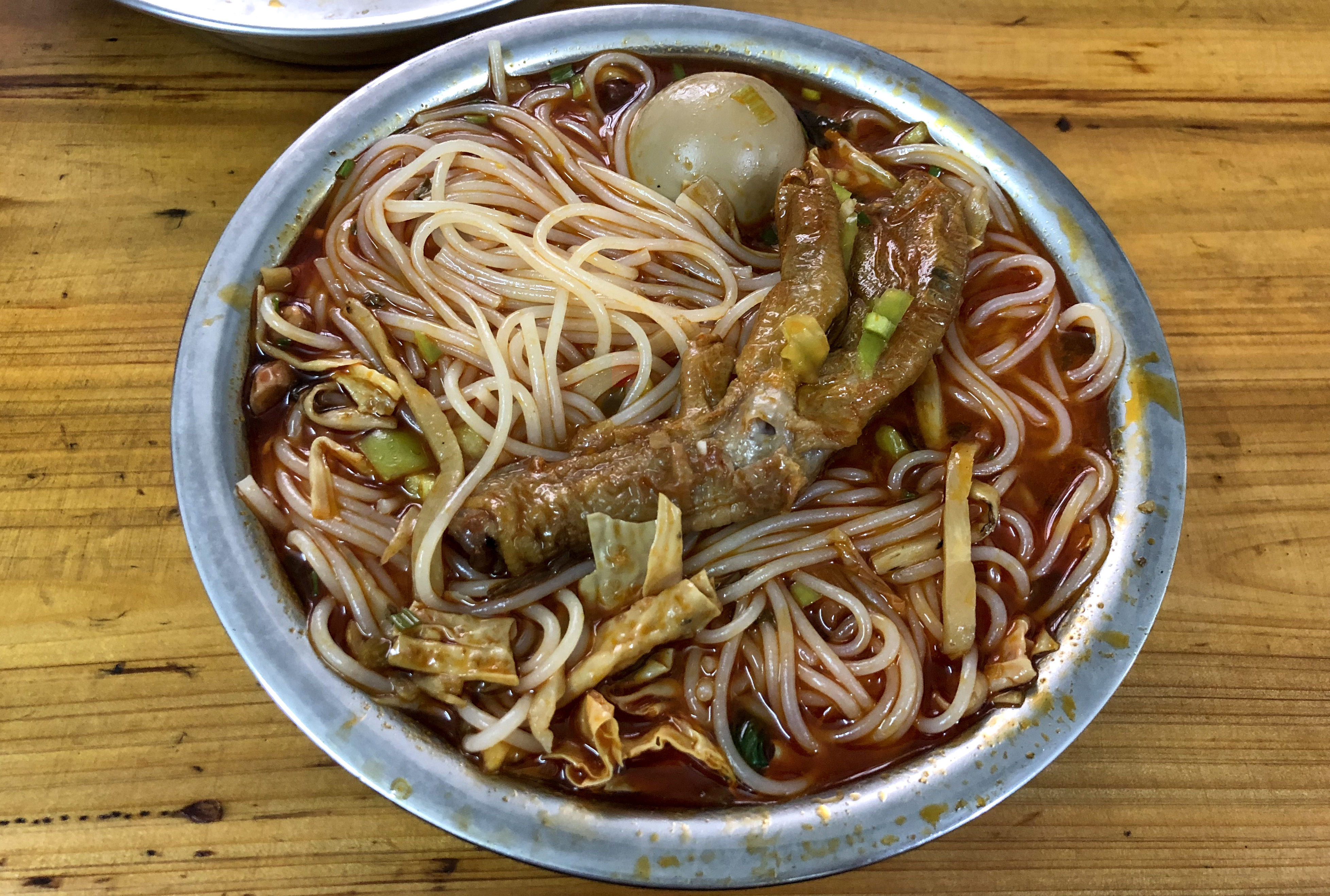 Liuzhou Luosifen rice noodles in spicy snail broth with pickled bamboo shoots and toppings