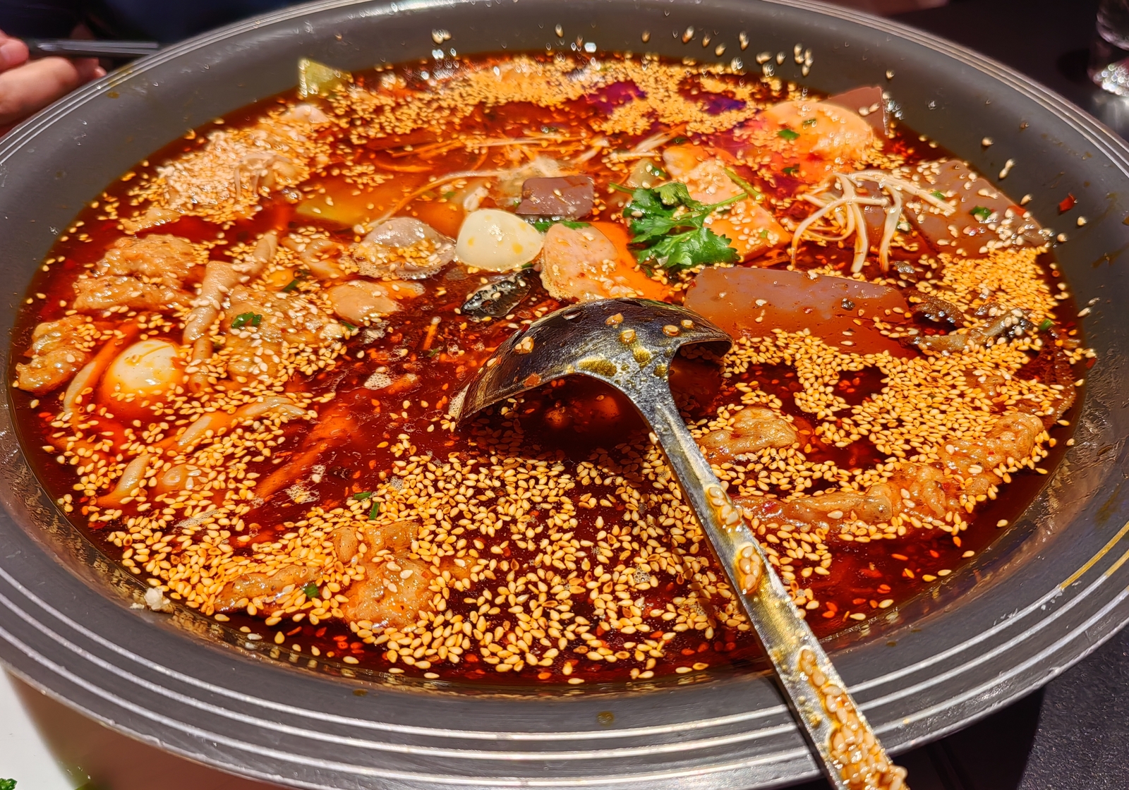 Authentic Mao Xue Wang spicy duck blood and tripe pot topped with chili oil and Sichuan peppercorn