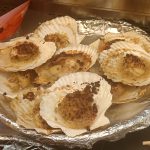Steamed scallops on the half shell with garlic and glass vermicelli