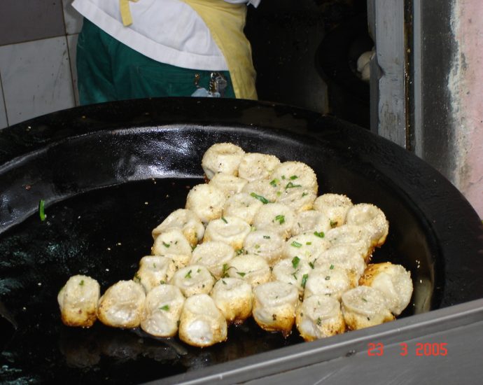 Shanghai Sheng Jian Bao pan-fried pork buns with sesame