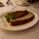 Crispy roast pork belly Siu Yuk with crackling skin at a Cantonese barbecue shop
