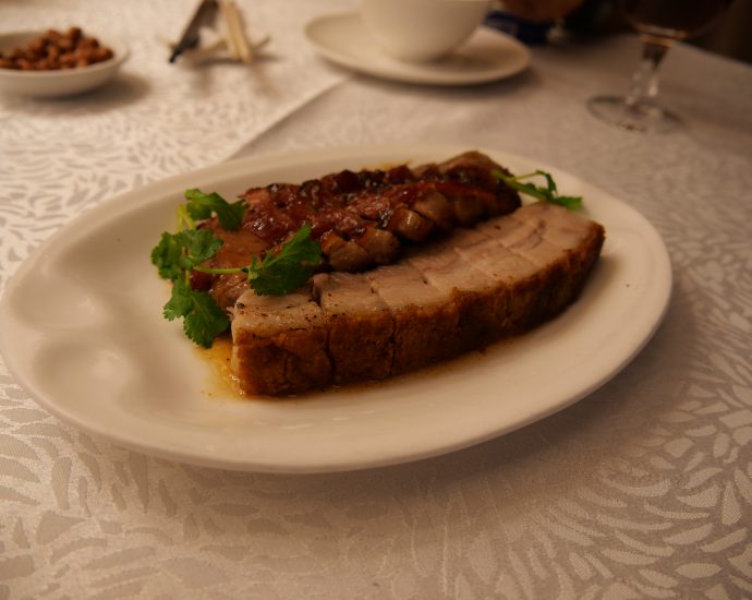 Crispy roast pork belly Siu Yuk with crackling skin at a Cantonese barbecue shop