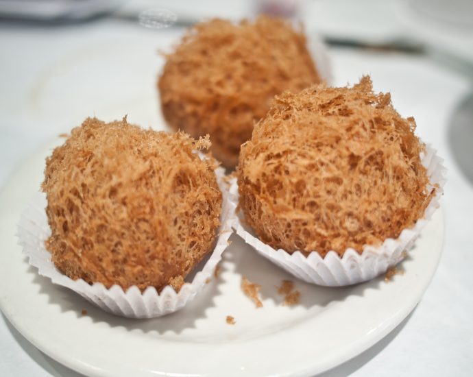 Woo Gok crispy deep-fried taro puffs filled with pork on a dim sum plate