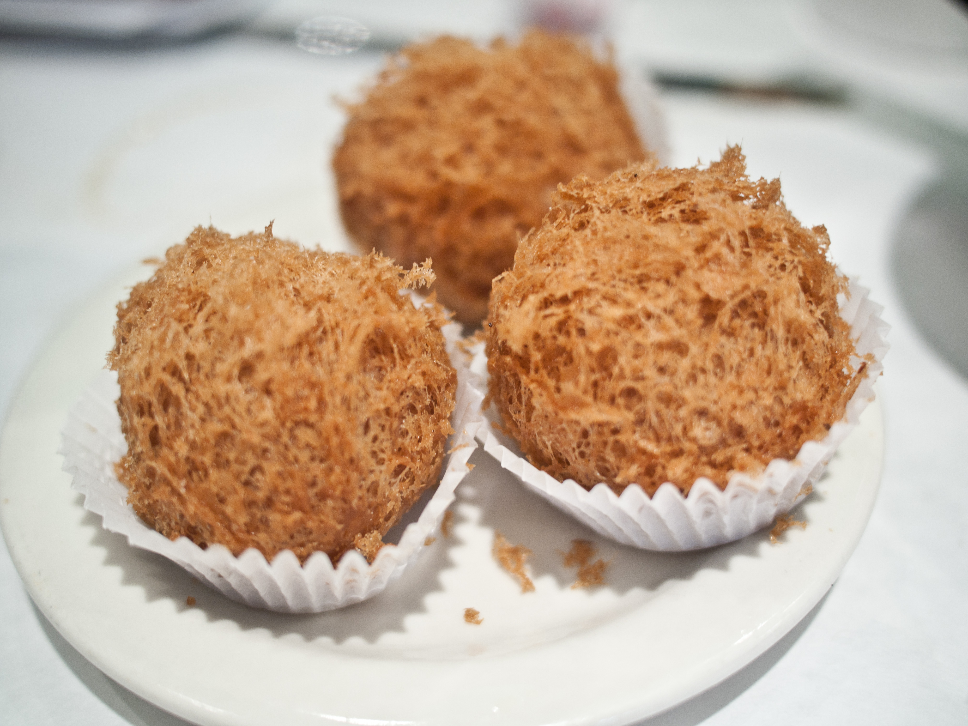 Woo Gok crispy deep-fried taro puffs with honeycomb crust on a dim sum plate