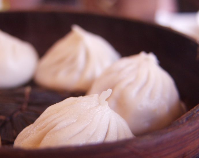 Steamed Shanghai soup dumplings Xiaolongbao in a bamboo steamer