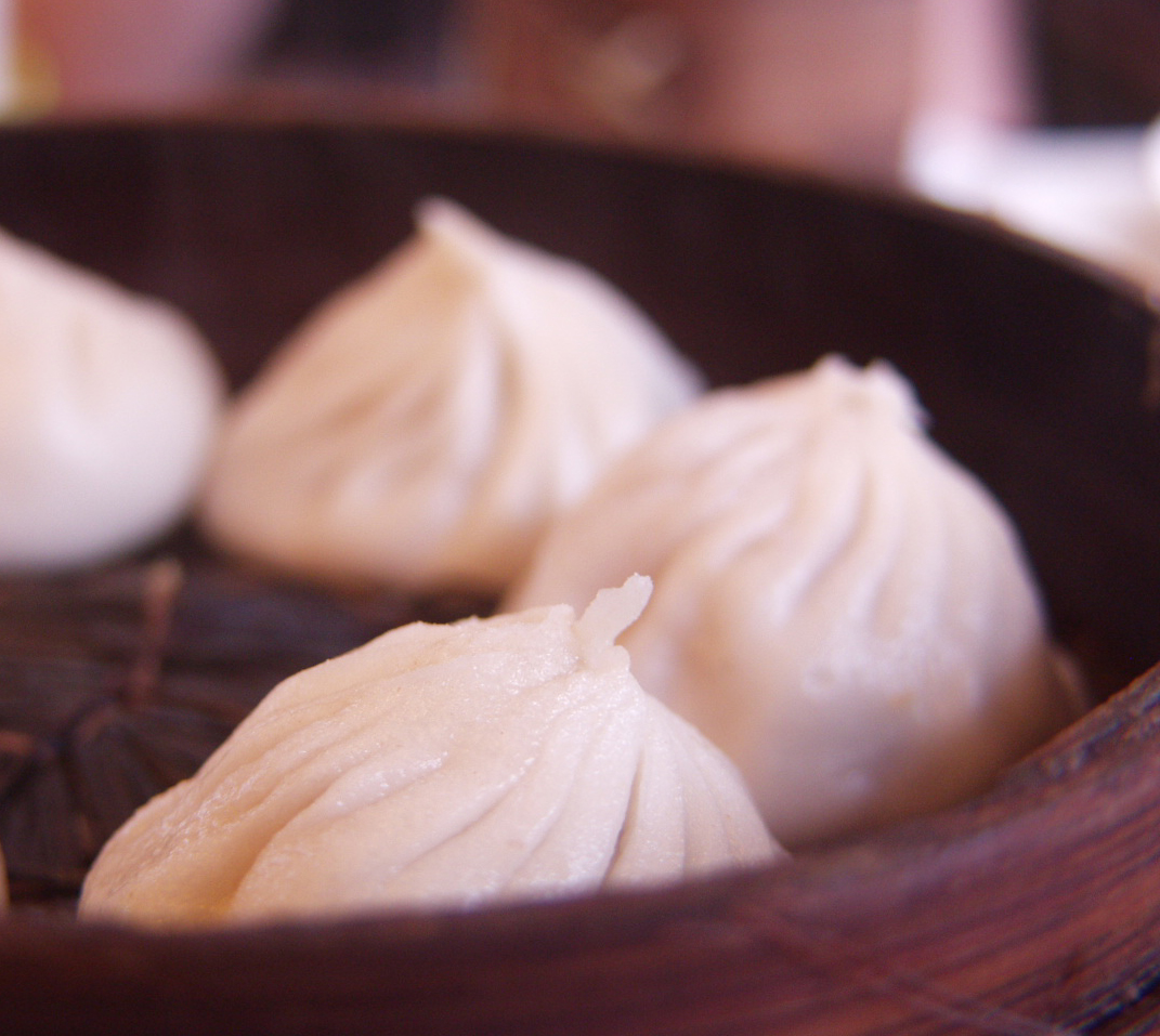 Steamed Shanghai Xiaolongbao soup dumplings with thin pleated wrappers